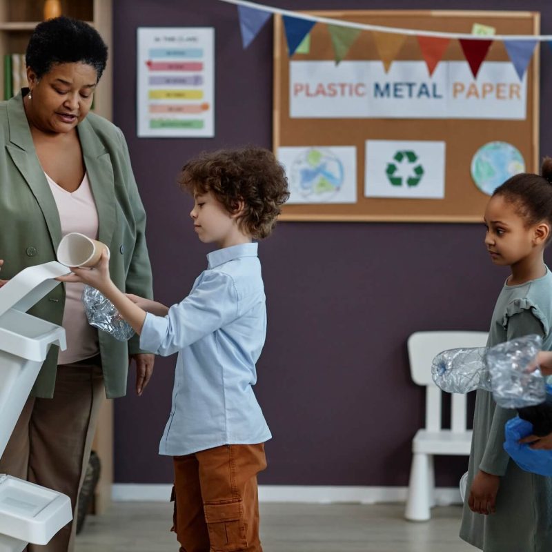 black-woman-teaching-little-kids-about-recycling-a-2023-11-27-05-29-44-utc